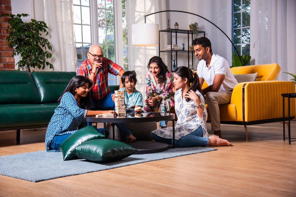 Multigenerational family enjoying comfortable home cooled by an air conditioner.